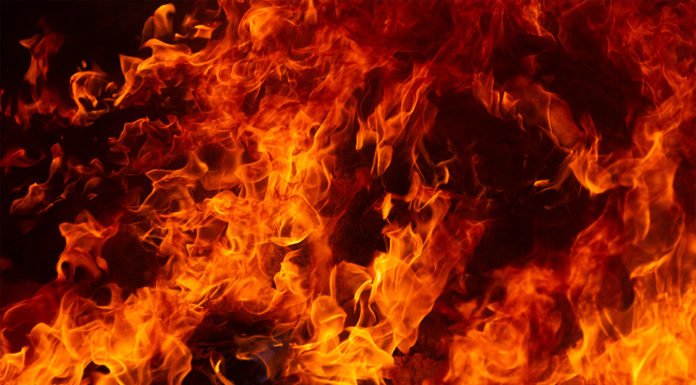 Cal Fire Riverside firefighters extinguish a blaze inside a home in Alberhill