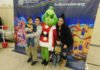 The Grinch helps children find green presents in Winchester’s Francis Domenigoni Community Center
