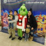 The Grinch helps children find green presents in Winchester’s Francis Domenigoni Community Center