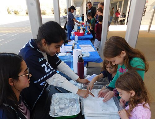 Children make their own snow at the Western Science Center’s Science Saturday