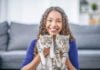 How pet sitters can benefit companion animals Woman with two cats