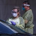 COVID-19 testing expands, as some restrictions loosen medical worker