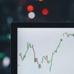 Stocks tick higher, gold rushes to record ahead of busy week