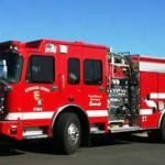 Blaze erupts in Lakeland Village, burning garage and threatening homes