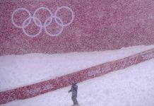 Skiers struggle as real snow falls on Winter Olympics
