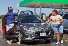 Hamilton students wash cars to raise funds for annual band trip