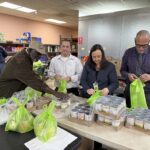 Volunteers help with rescue food packaging at Menifee’s Community Cupboard during wind crisis